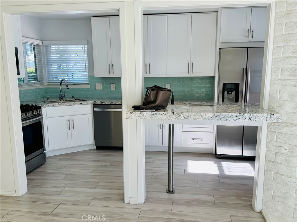 34095 Aurelio Dana Point, CA 92629 - Photo 7 of 32 a kitchen with stainless steel appliances granite countertop a sink stove and refrigerator