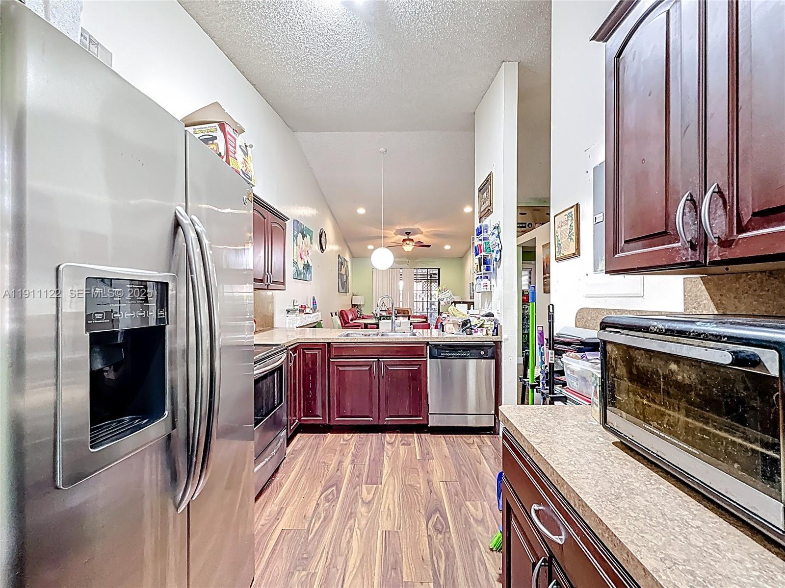 6722 Northwest 192nd Lane Hialeah, FL 33015 - Photo 15 of 46 a kitchen with stainless steel appliances granite countertop a refrigerator and a stove top oven