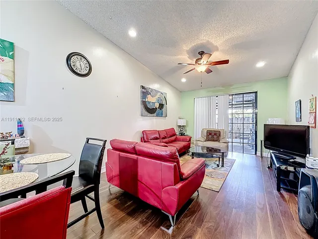 a view of a livingroom with furniture and a flat screen tv