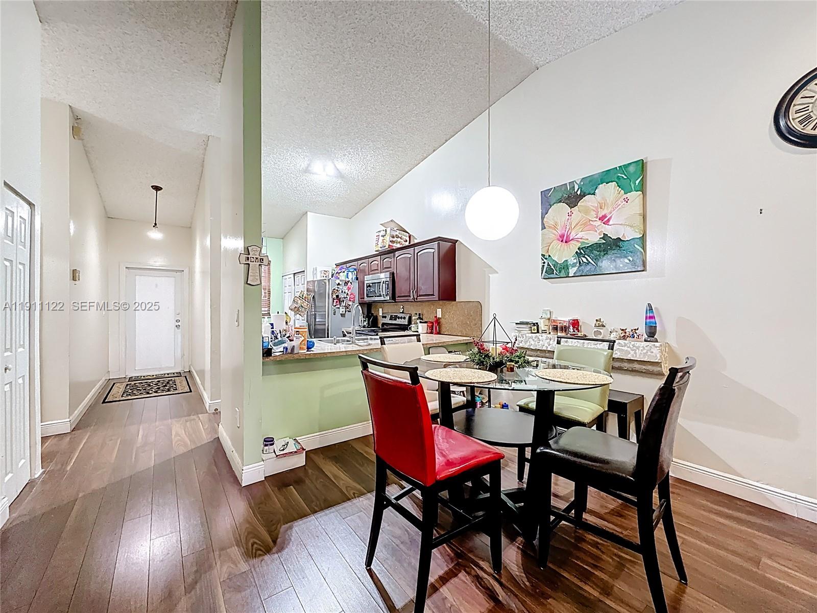 6722 Northwest 192nd Lane Hialeah, FL 33015 - Photo 17 of 46 a view of a dining room with furniture a rug and wooden floor