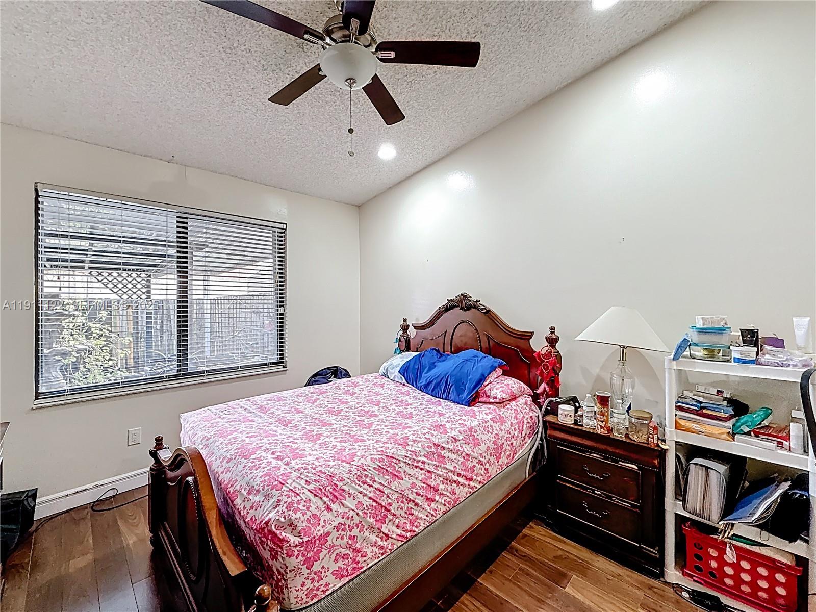 6722 Northwest 192nd Lane Hialeah, FL 33015 - Photo 21 of 46 a bedroom with bed and a window