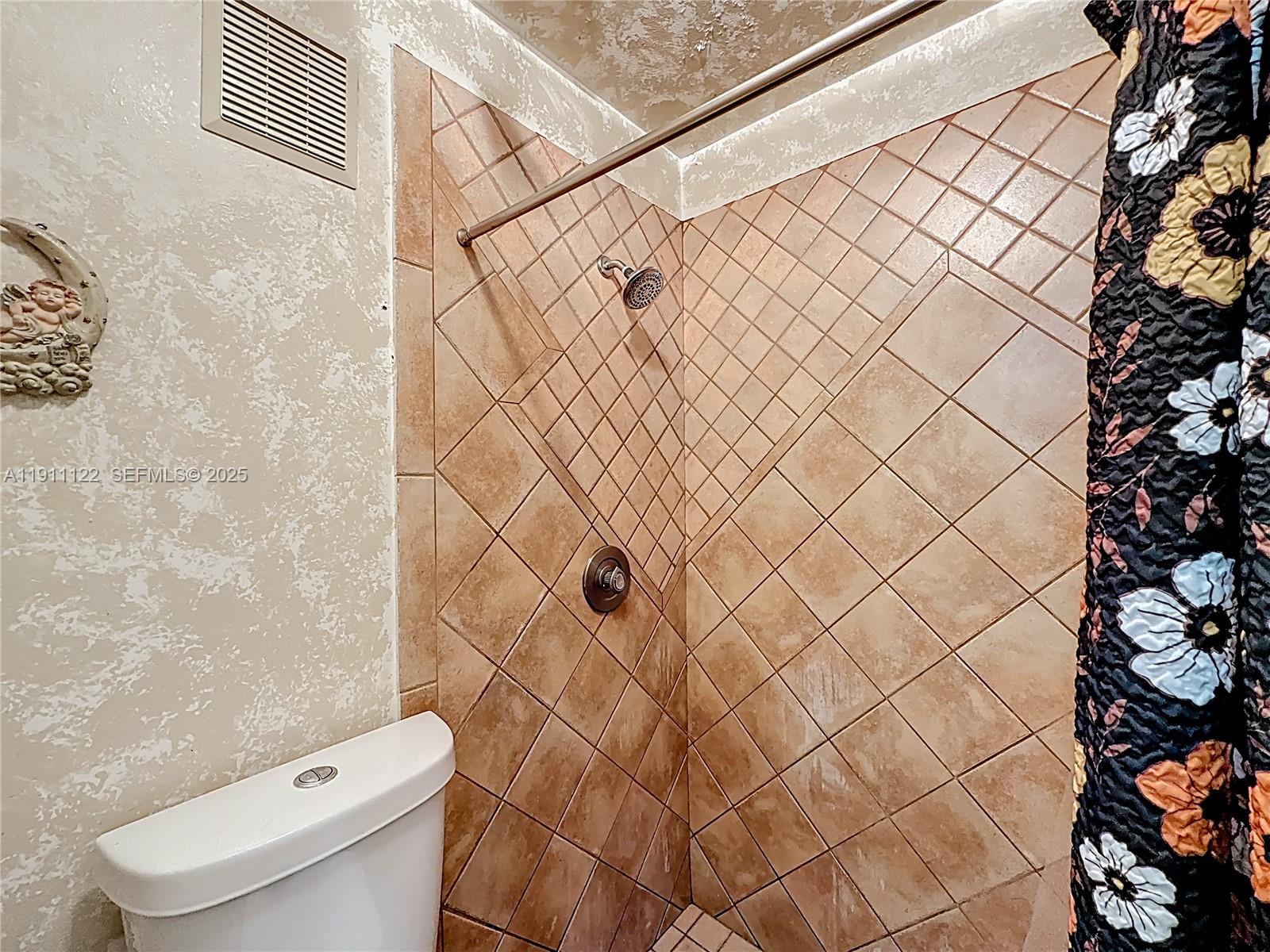 6722 Northwest 192nd Lane Hialeah, FL 33015 - Photo 26 of 46 a bathroom with a toilet and a shower