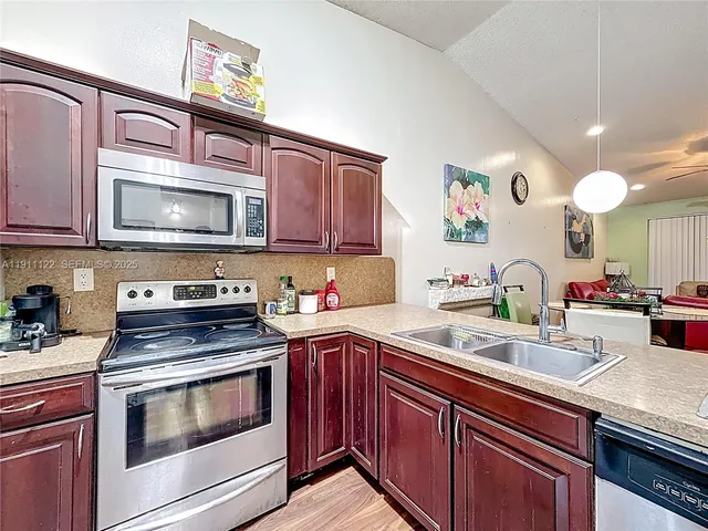 a kitchen with stainless steel appliances granite countertop a sink and stove top oven