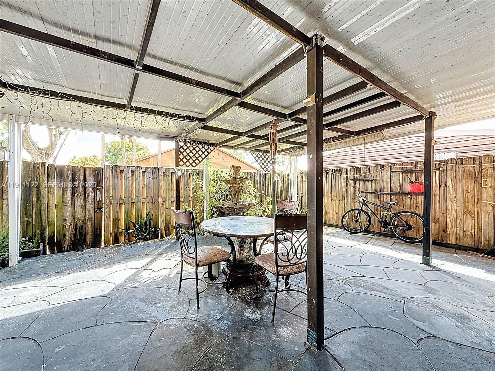 6722 Northwest 192nd Lane Hialeah, FL 33015 - Photo 33 of 46 a view of a patio with table and chairs and potted plants