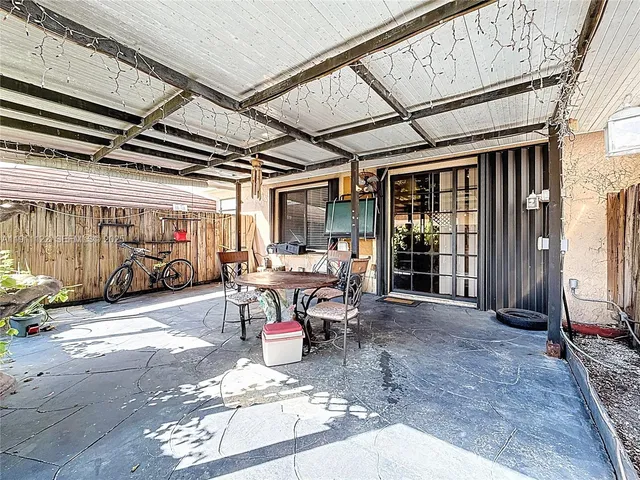 a view of a patio with table and chairs and potted plants