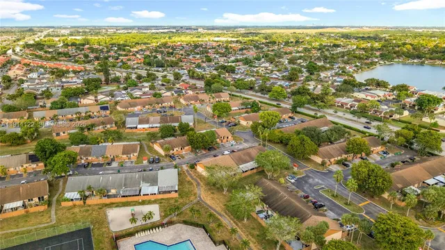 an aerial view of residential building and lake