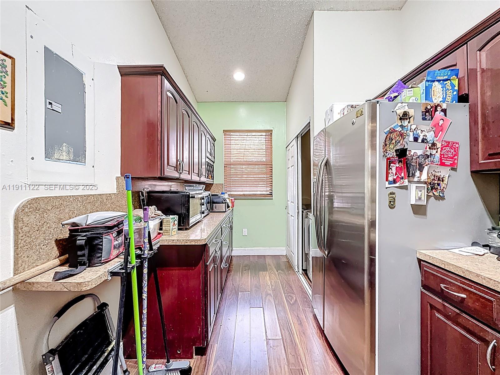 6722 Northwest 192nd Lane Hialeah, FL 33015 - Photo 4 of 46 a kitchen with stainless steel appliances granite countertop a refrigerator and a stove top oven