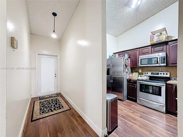 a kitchen with stainless steel appliances a refrigerator and a stove top oven