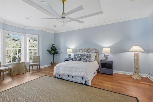 a bedroom with a large bed and a chandelier