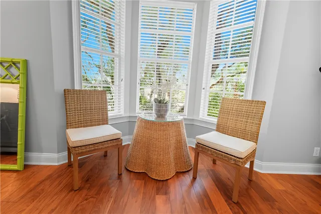 a room with wooden floor and windows