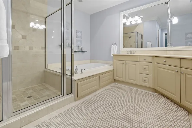 a spacious bathroom with a shower sink and mirror