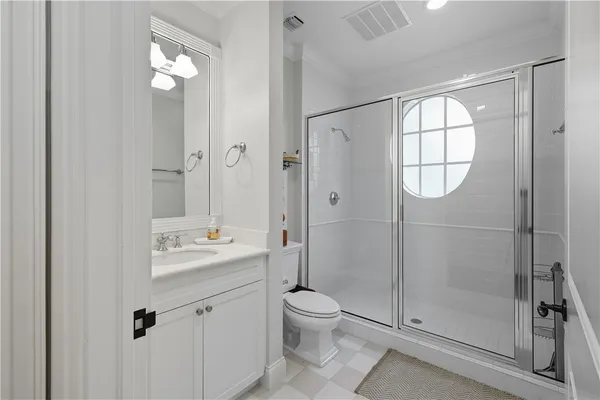 a bathroom with a toilet a sink and shower