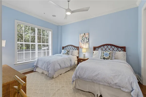 a spacious bedroom with two beds and a window