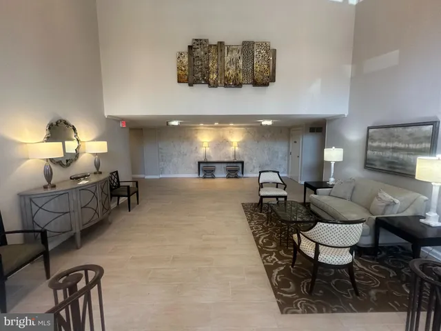 a living room with furniture and a lamp