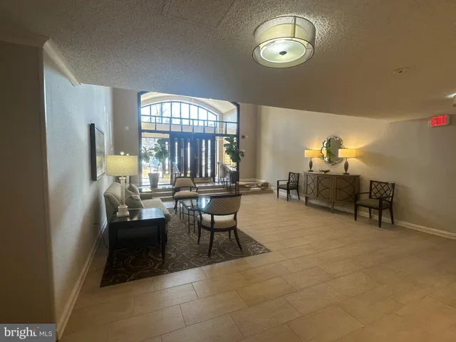 a view of a livingroom with furniture and a large window