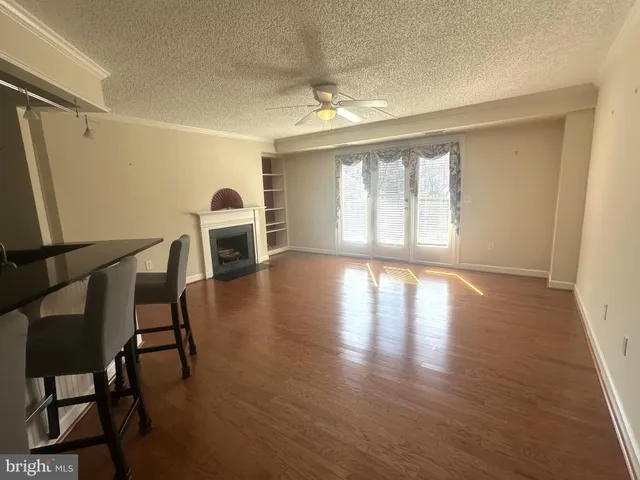 a view of a livingroom with furniture window and wooden floor