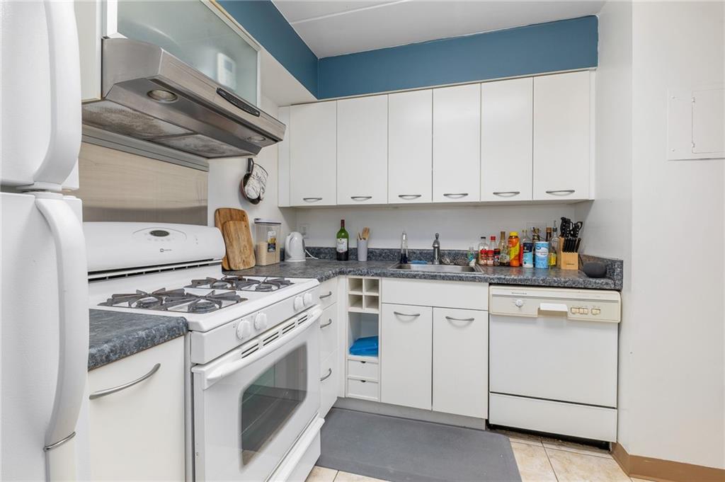 5 Bayard Road, Unit 808 Pittsburgh, PA 15213 - Photo 11 of 33 a kitchen with white cabinets and white appliances
