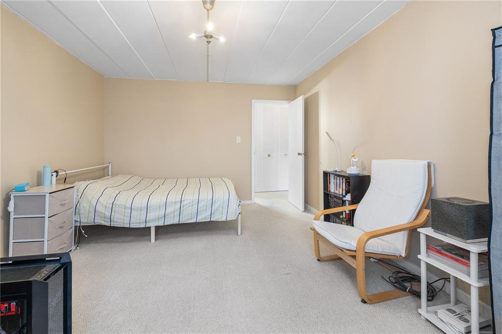 5 Bayard Road, Unit 808 Pittsburgh, PA 15213 - Photo 17 of 33 a bedroom with a bed and a chair