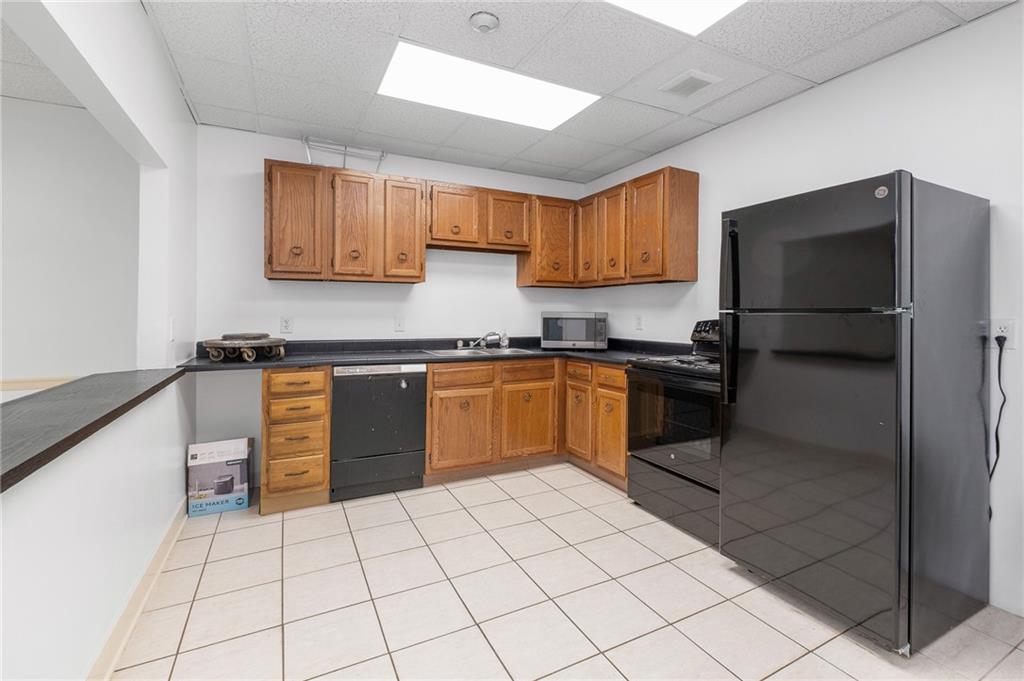5 Bayard Road, Unit 808 Pittsburgh, PA 15213 - Photo 24 of 33 a kitchen with a sink a stove top oven and cabinetry