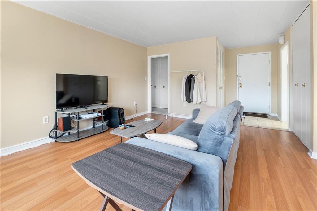 5 Bayard Road, Unit 808 Pittsburgh, PA 15213 - Photo 8 of 33 a living room with furniture and a flat screen tv