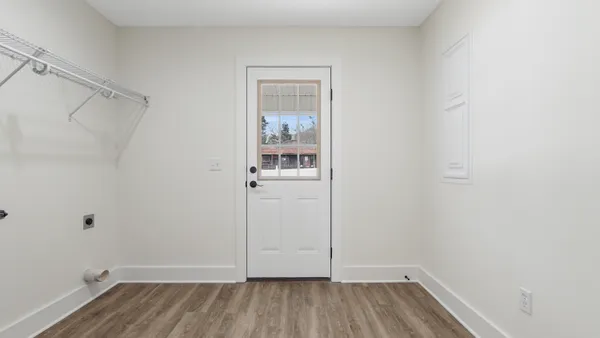a view of a room with wooden floor