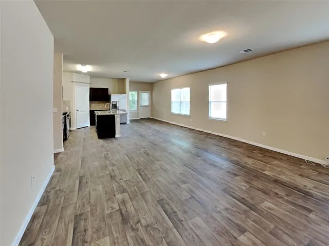 a kitchen with kitchen island sink refrigerator and cabinets