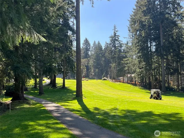 a view of a swimming pool with an outdoor space and seating area