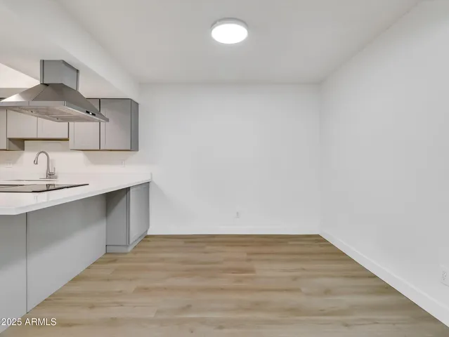a kitchen with granite countertop a sink and a stove top oven
