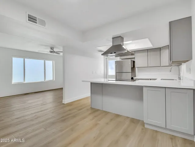 a kitchen with stainless steel appliances a refrigerator and a stove
