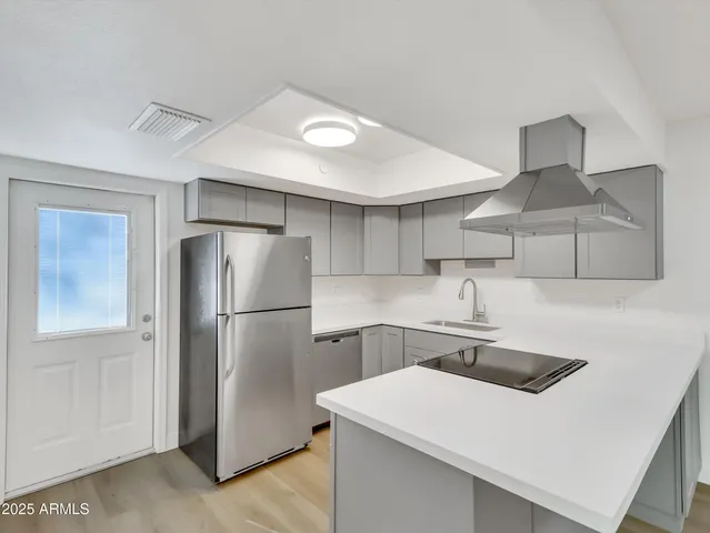 a kitchen with a sink cabinets and stainless steel appliances