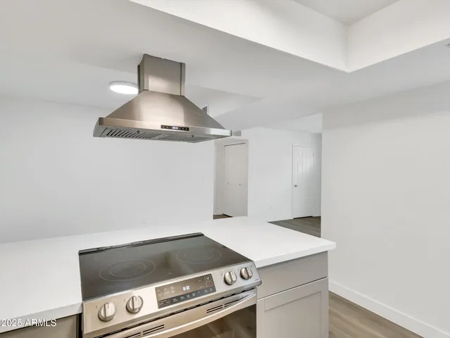 an empty room with a window and a ceiling fan