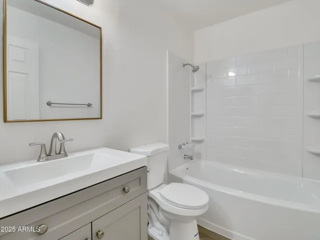 an empty room with window and wooden floor