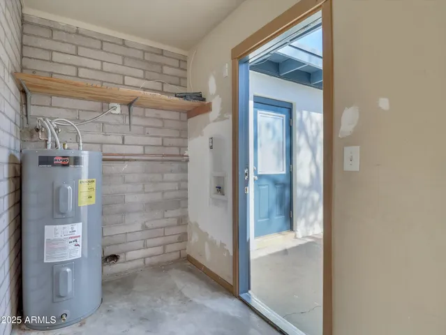 a view of a room with a sink cabinetry and a ceiling fan