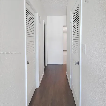 a view of a hallway with a wooden floor