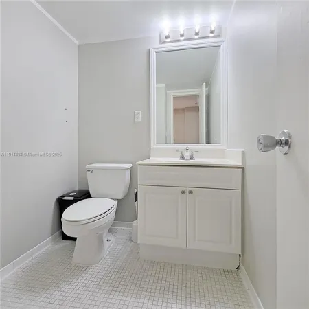 a bathroom with a sink toilet and mirror