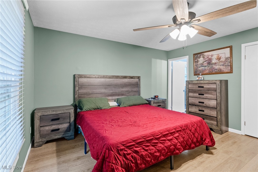 7944 Middle Ridge Road Madison, OH 44057 - Photo 18 of 31 Bedroom featuring light wood-style floors and ceiling fan