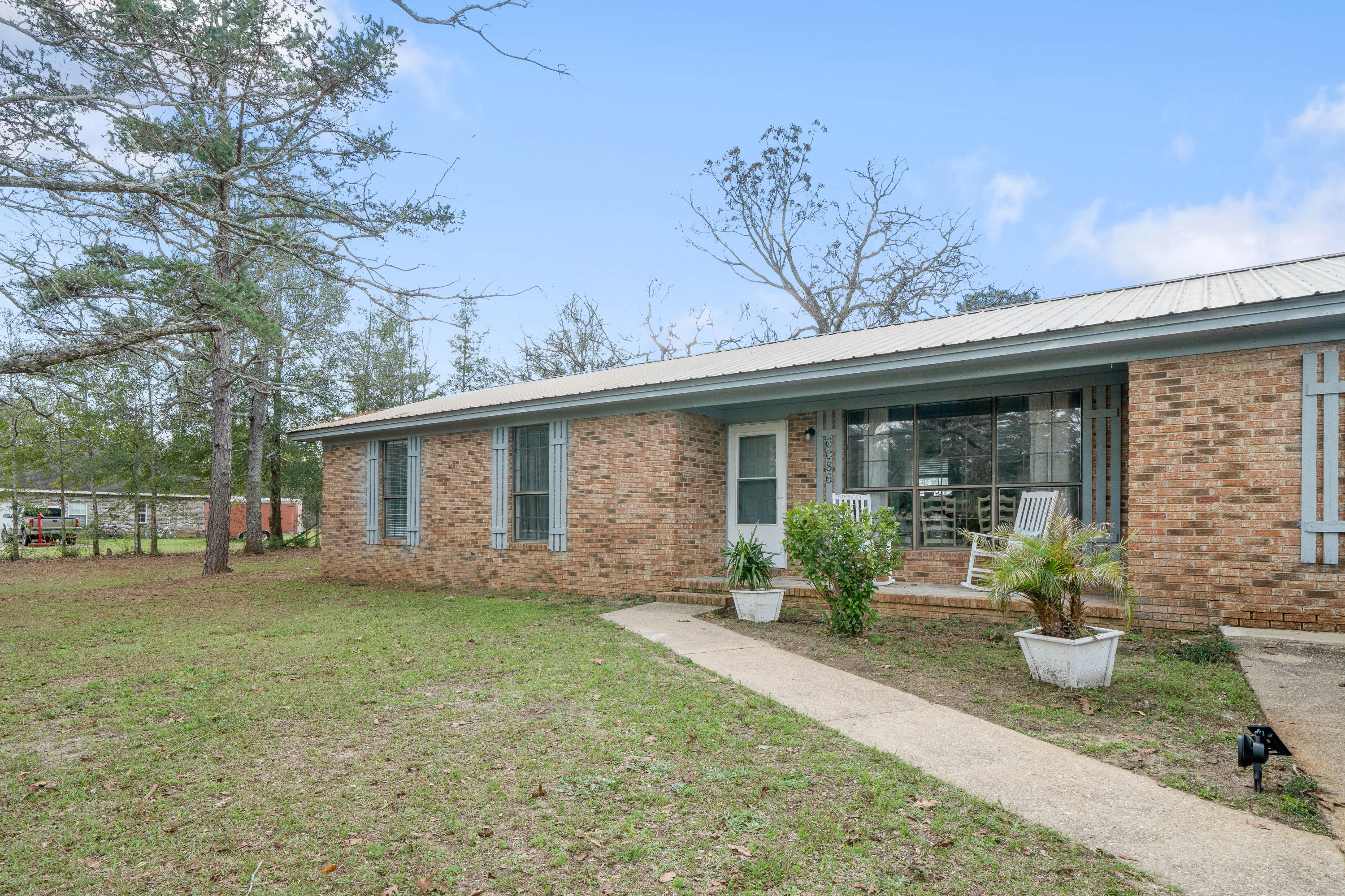 6086 Robin Road Crestview, FL 32539 - Photo 2 of 30 a front view of a house with garden