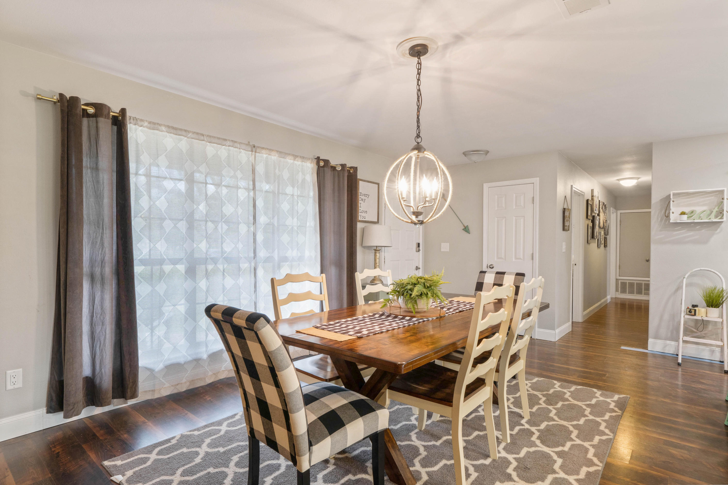 6086 Robin Road Crestview, FL 32539 - Photo 11 of 30 a view of a dining room with furniture wooden floor and chandelier