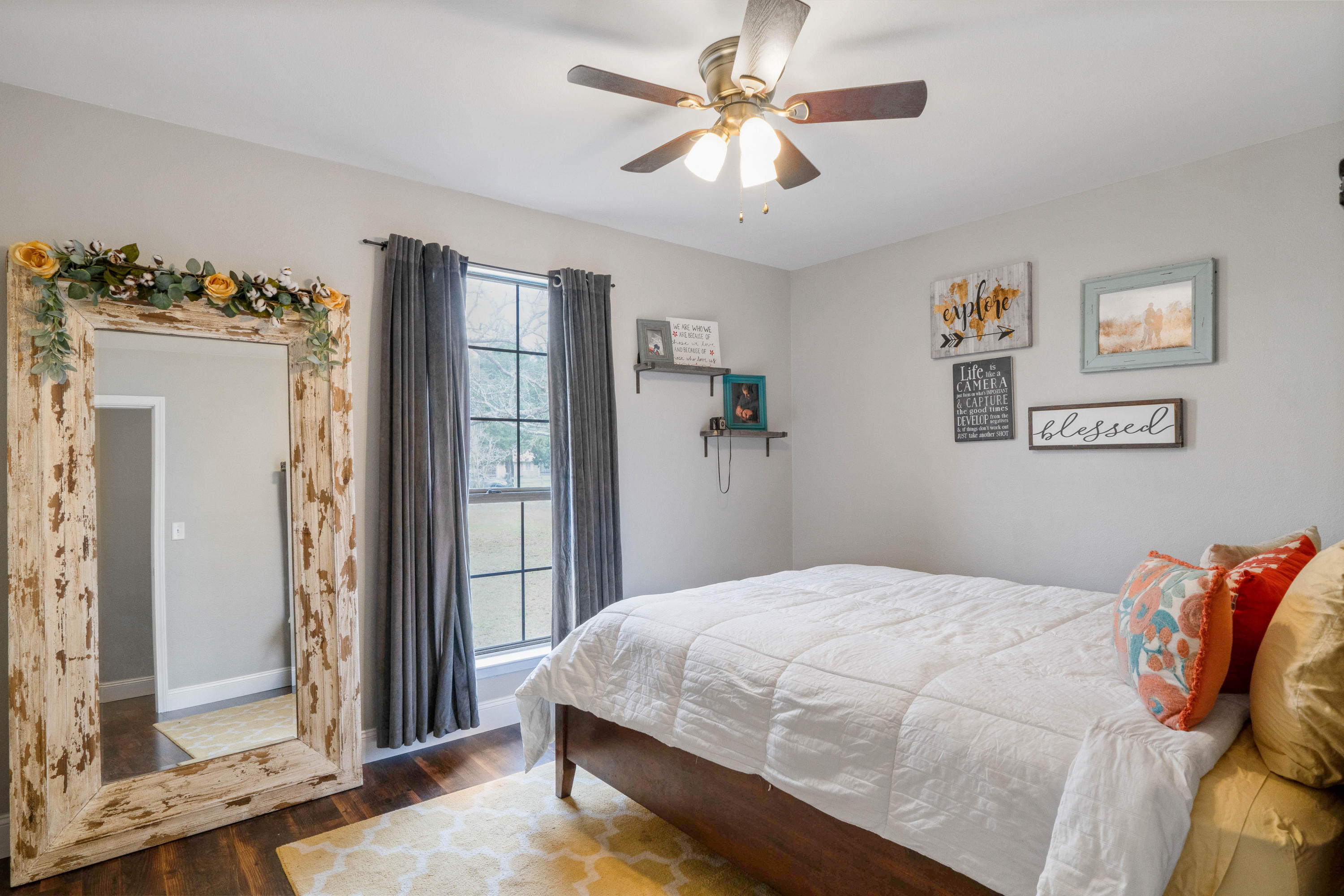 6086 Robin Road Crestview, FL 32539 - Photo 16 of 30 a bedroom with a large bed and a chandelier