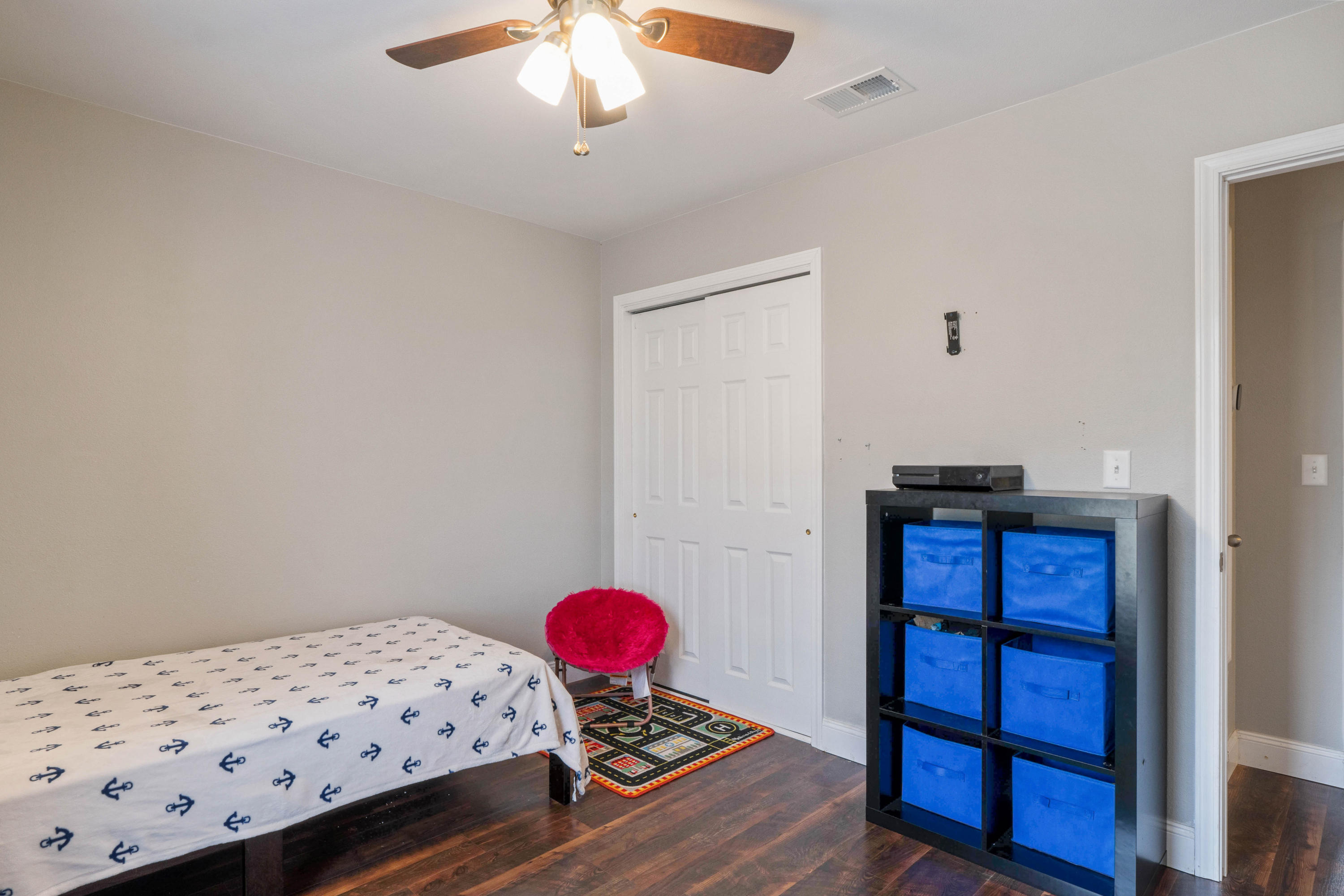 6086 Robin Road Crestview, FL 32539 - Photo 19 of 30 a bedroom with a bed and wooden floor