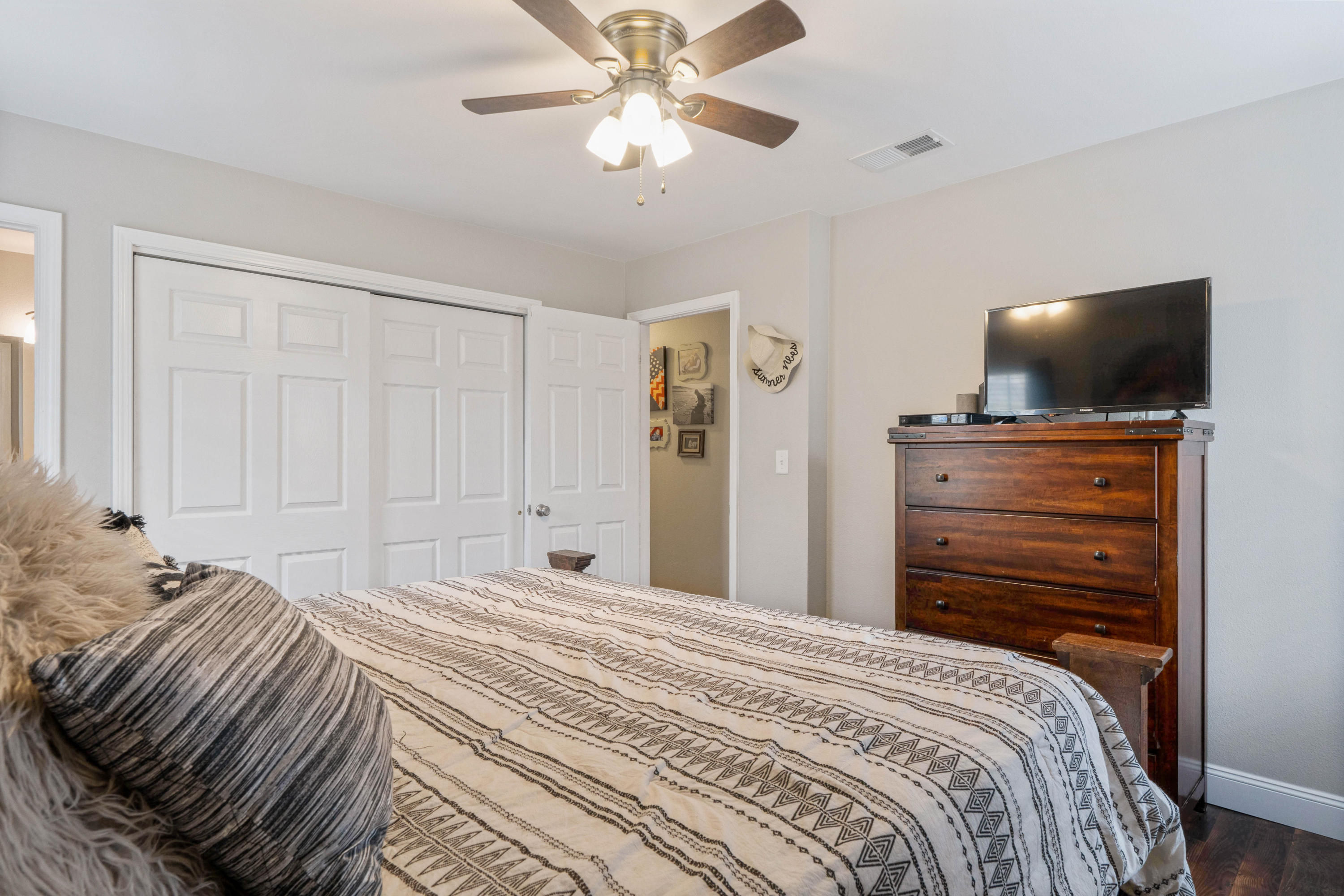 6086 Robin Road Crestview, FL 32539 - Photo 21 of 30 a bedroom with a bed and a flat tv screen on dresser