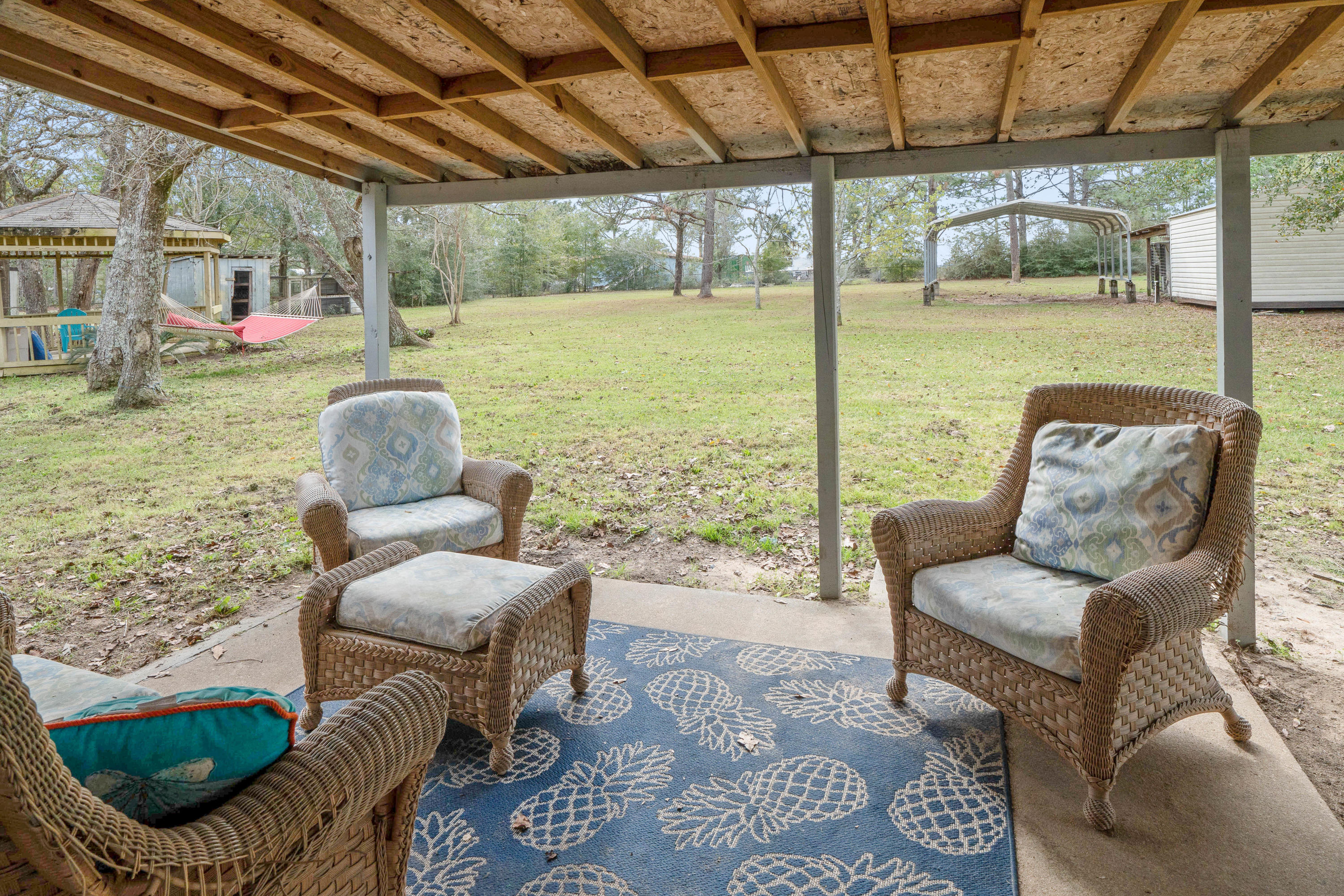 6086 Robin Road Crestview, FL 32539 - Photo 25 of 30 a outdoor living space with furniture and a garden