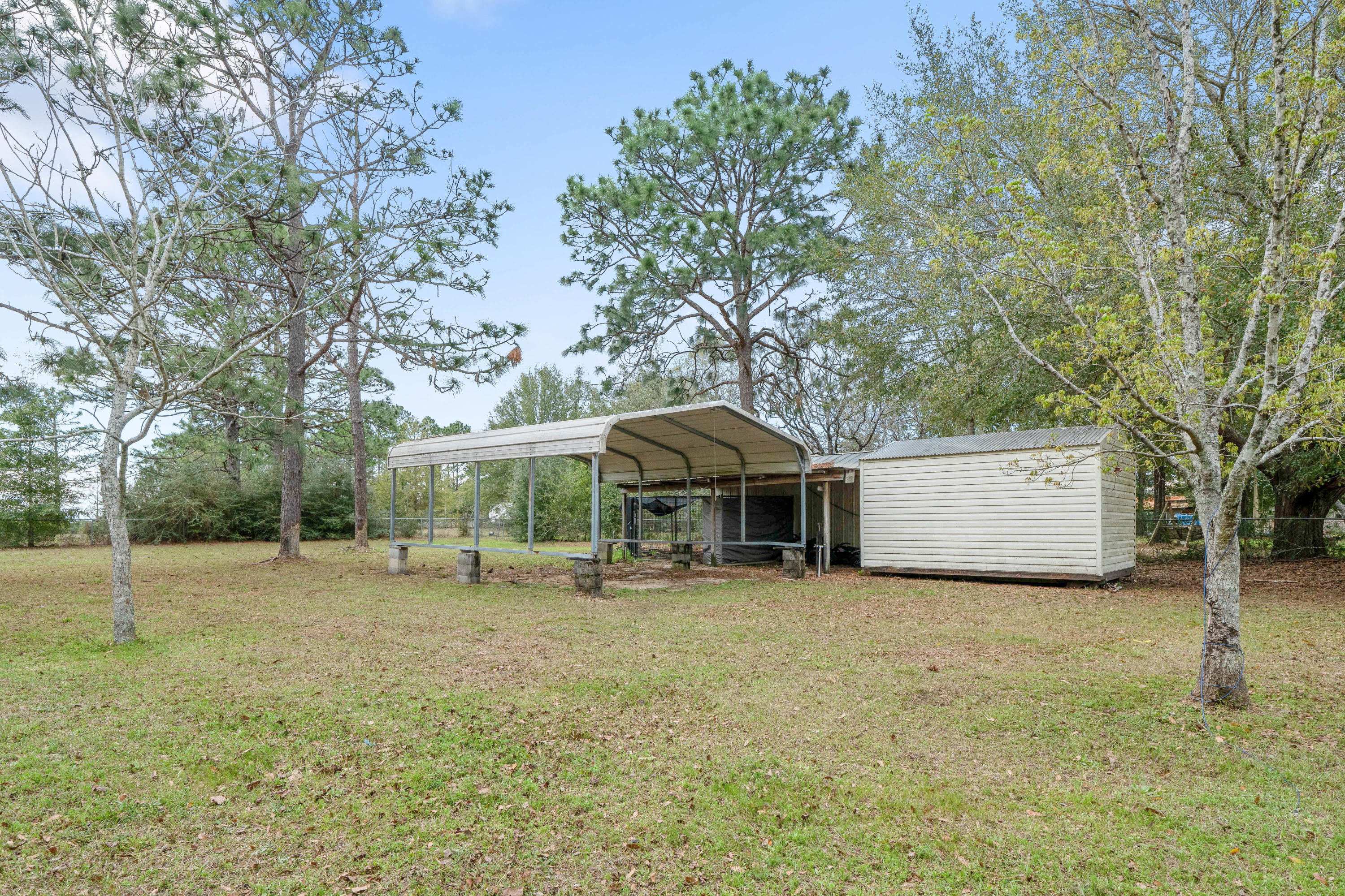 6086 Robin Road Crestview, FL 32539 - Photo 29 of 30 a view of a house with a yard and large tree