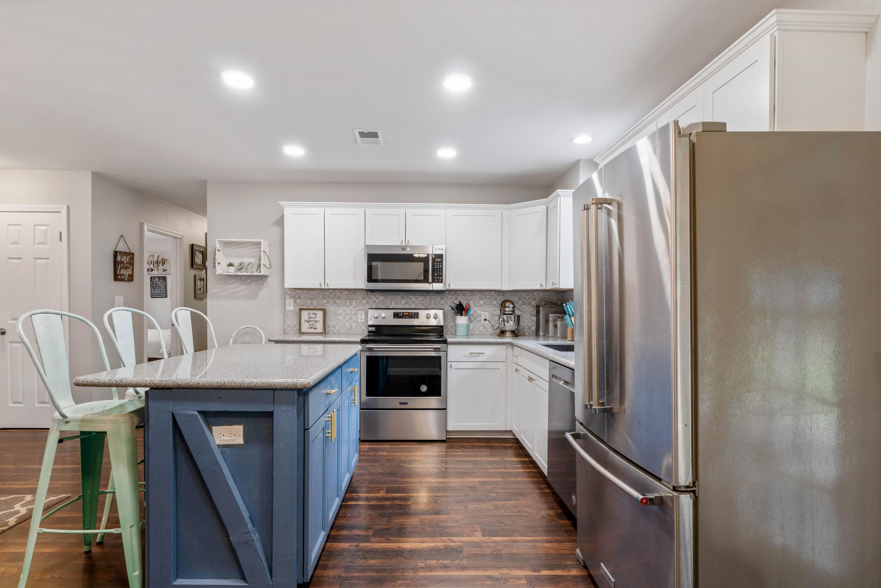 6086 Robin Road Crestview, FL 32539 - Photo 5 of 30 a kitchen with granite countertop a refrigerator a sink a stove top oven a dining table and chairs