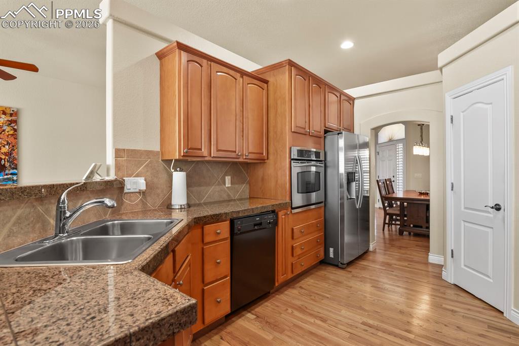 617 Concerto Drive Colorado Springs, CO 80906 - Photo 10 of 46 The kitchen features granite tile countertops, wood cabinetry, stainless steel oven & refrigerator and hardwood flooring