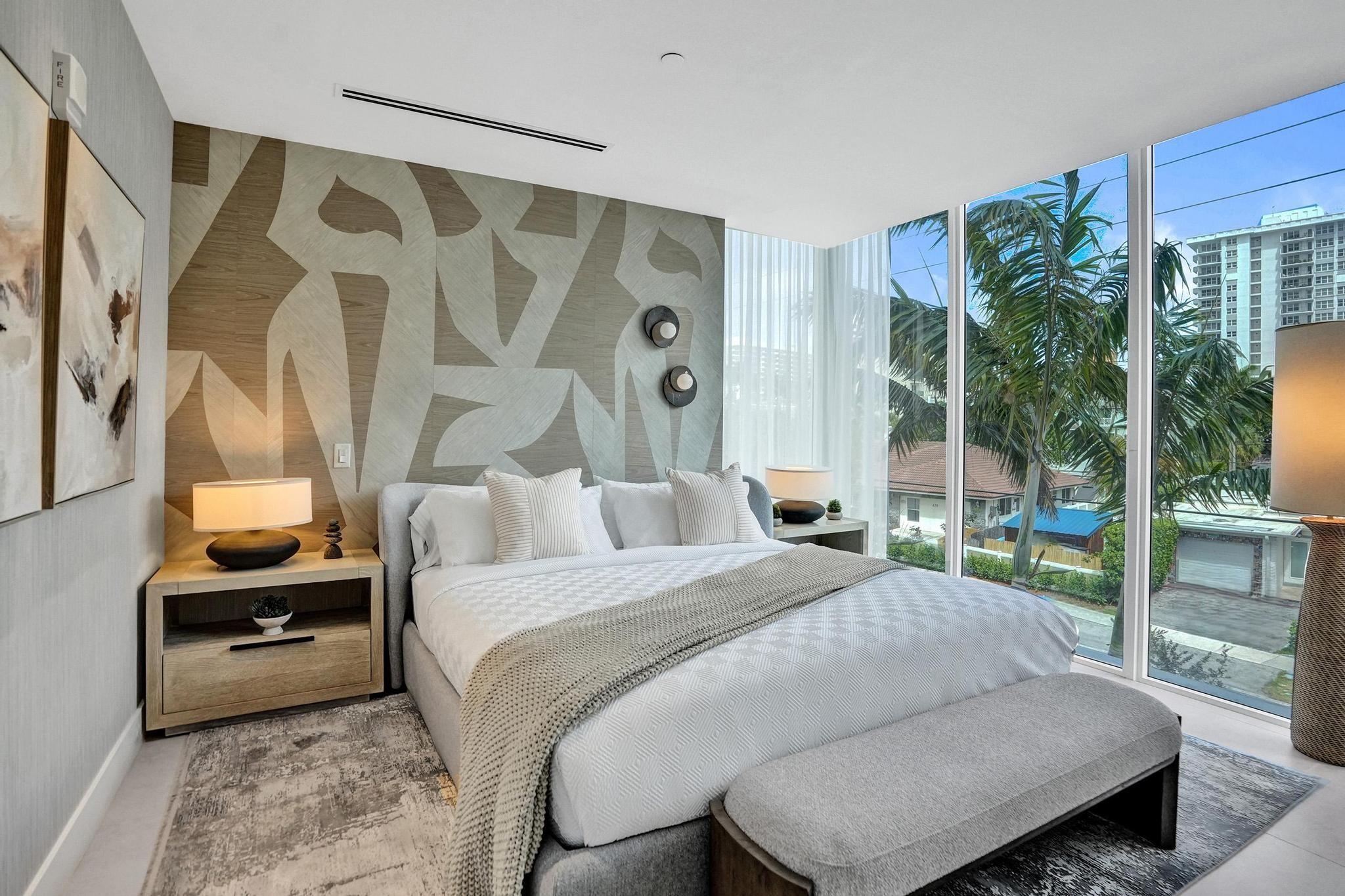 407 North Riverside Drive, Unit 203 Pompano Beach, FL 33062 - Photo 21 of 69 a bedroom with a bed and a night stand