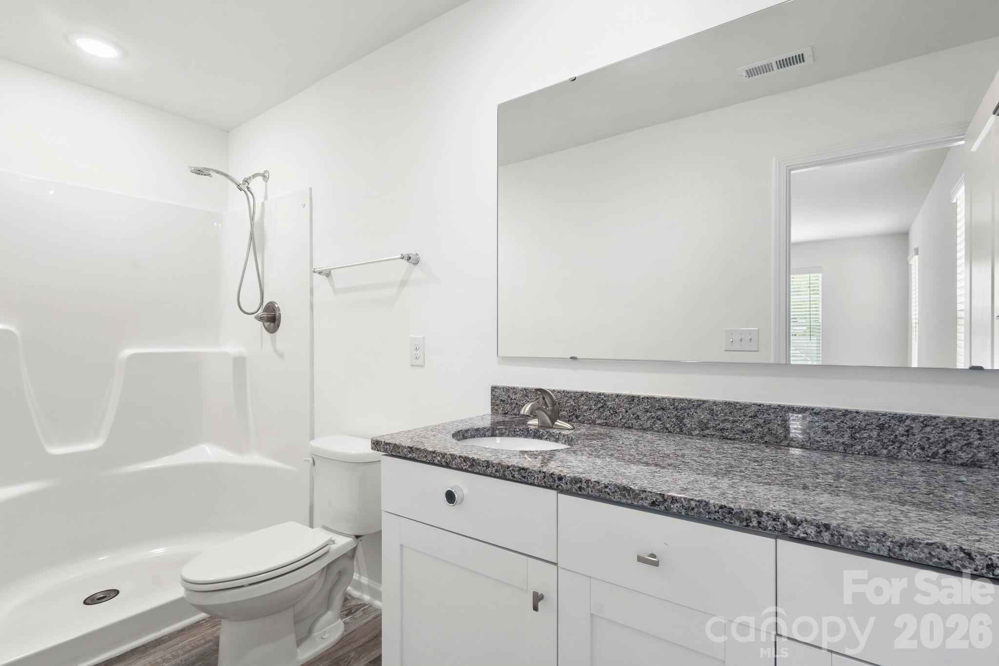 112 Angle Street Cherryville, NC 28021 - Photo 20 of 46 a bathroom with a granite countertop sink a toilet and a shower