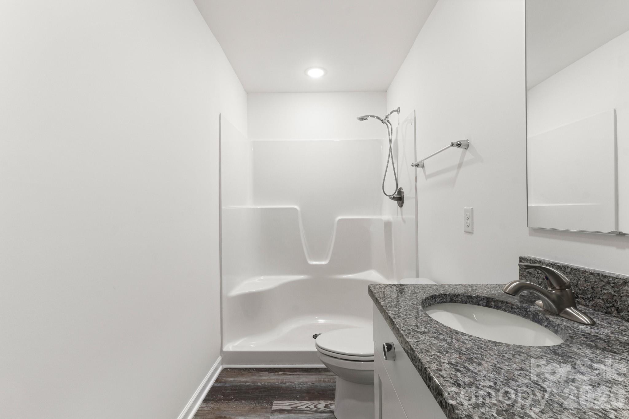 112 Angle Street Cherryville, NC 28021 - Photo 21 of 46 a bathroom with a granite countertop sink toilet and shower