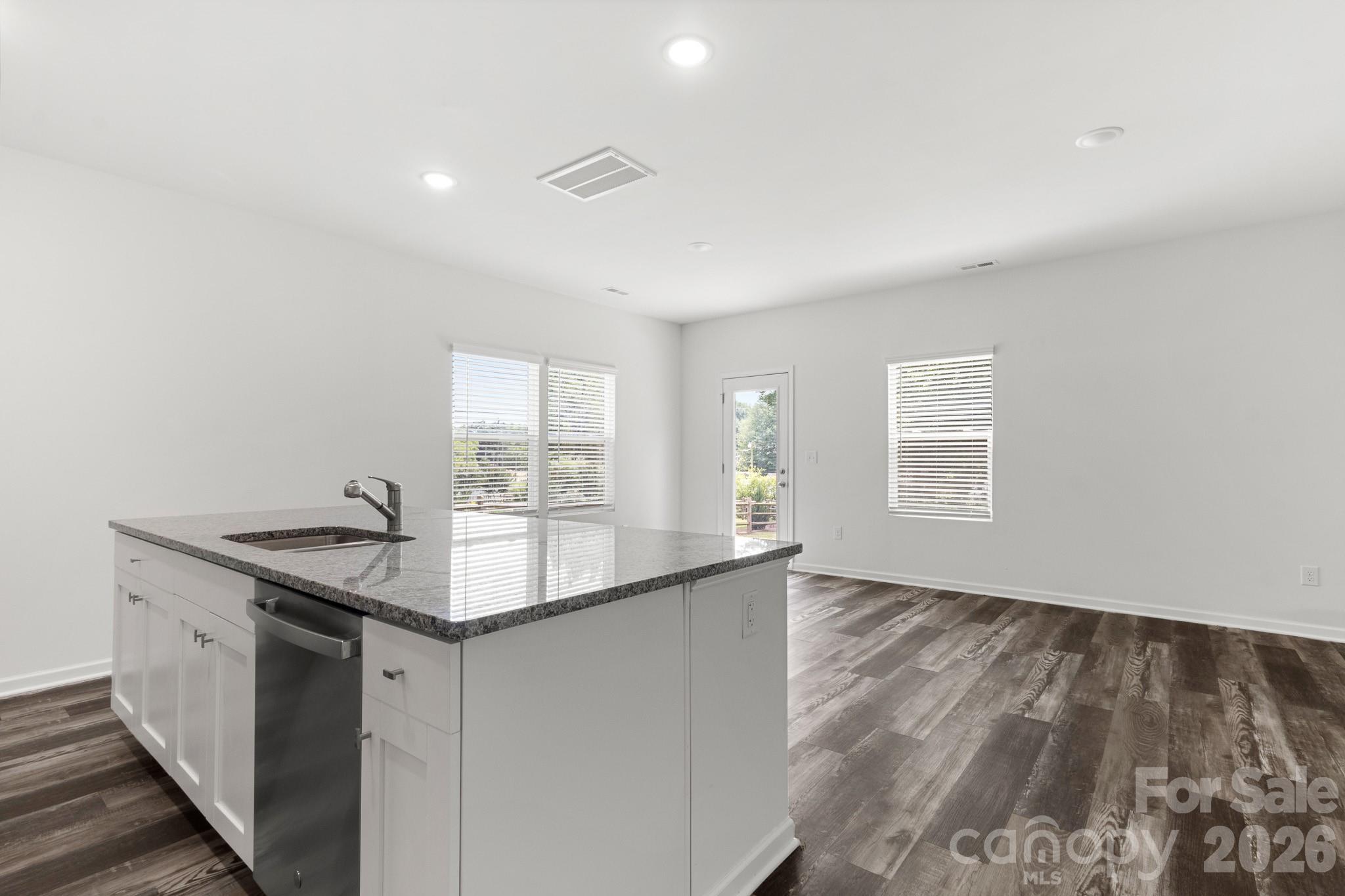 112 Angle Street Cherryville, NC 28021 - Photo 32 of 46 a kitchen with granite countertop a sink and dishwasher with wooden floor