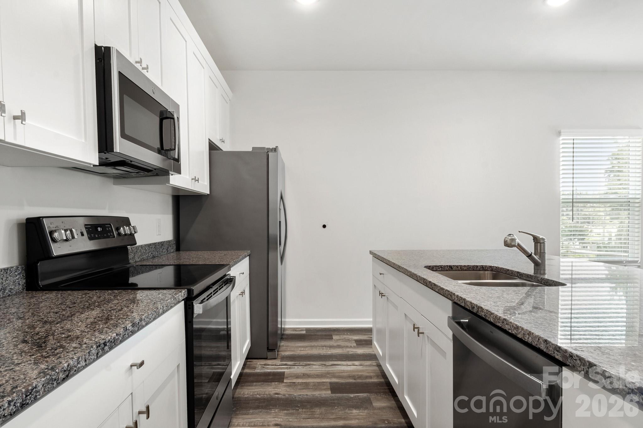 112 Angle Street Cherryville, NC 28021 - Photo 33 of 46 a kitchen with stainless steel appliances granite countertop a sink stove and refrigerator